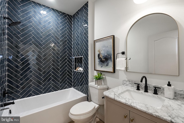 bathroom featuring toilet, shower / washtub combination, and vanity