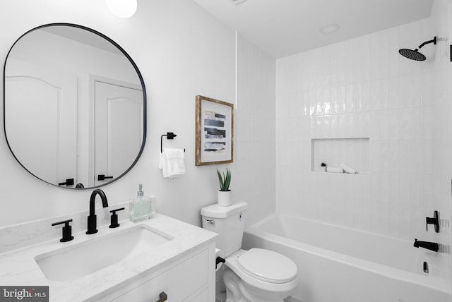 bathroom featuring toilet, vanity, and bathing tub / shower combination