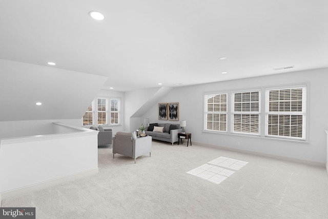 living area featuring recessed lighting, light carpet, visible vents, baseboards, and vaulted ceiling