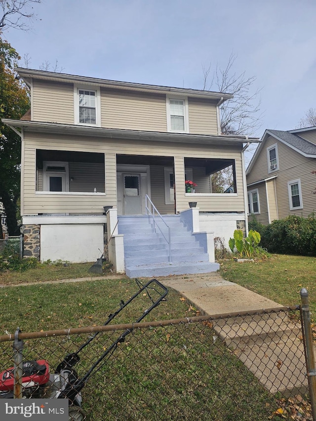 view of property featuring covered porch and a front lawn