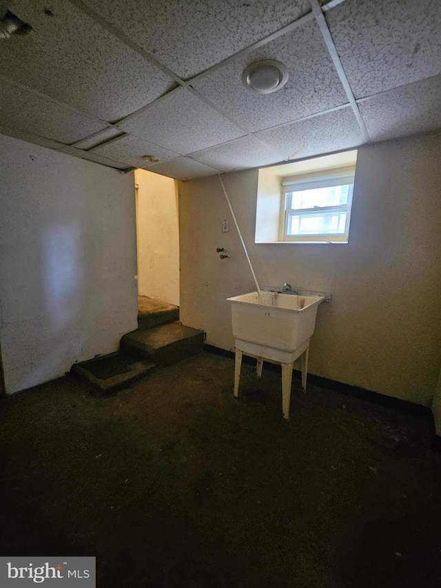 basement featuring a paneled ceiling