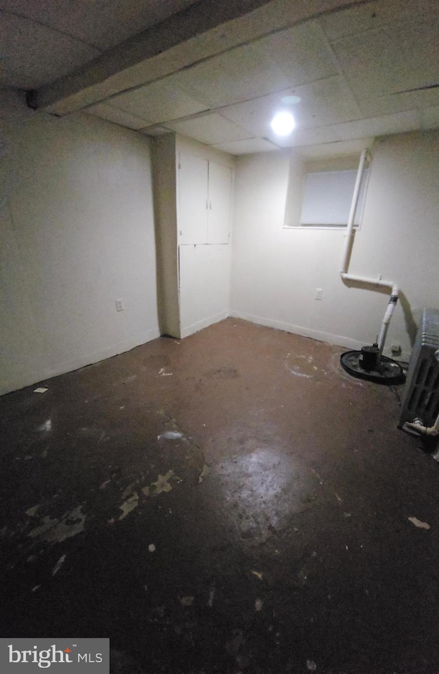 basement featuring a paneled ceiling