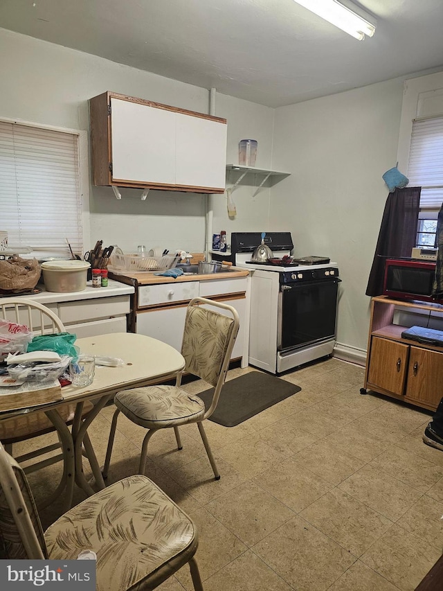 kitchen with white cabinetry and gas stove