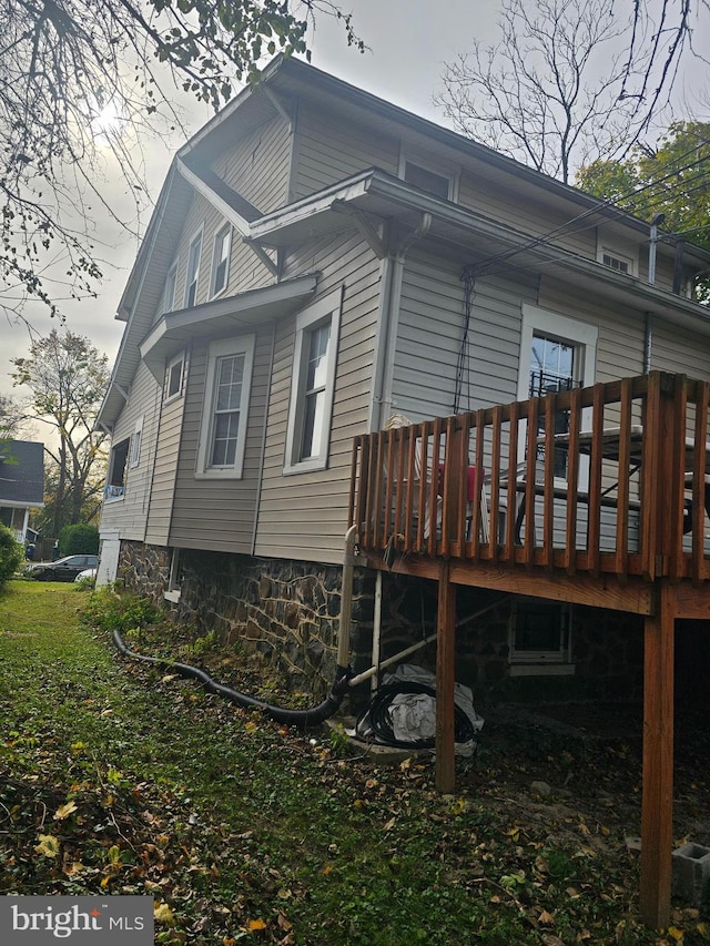 view of property exterior featuring a wooden deck