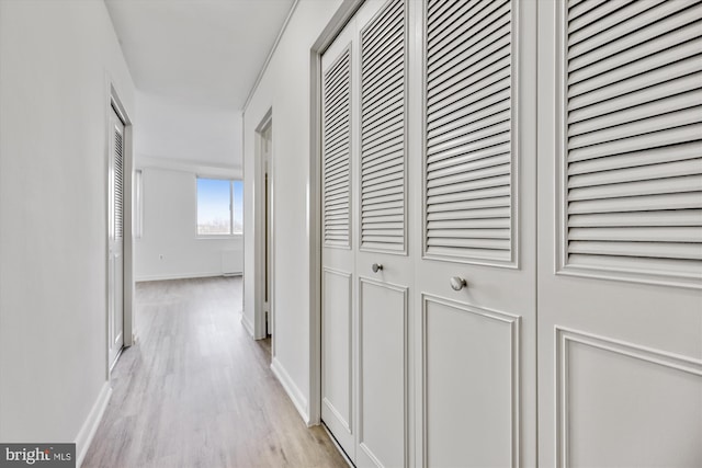 hallway featuring radiator and light hardwood / wood-style floors