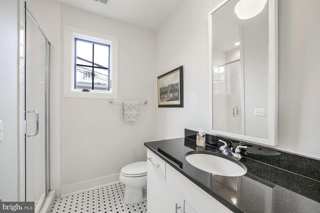 bathroom with vanity, toilet, and a shower with shower door