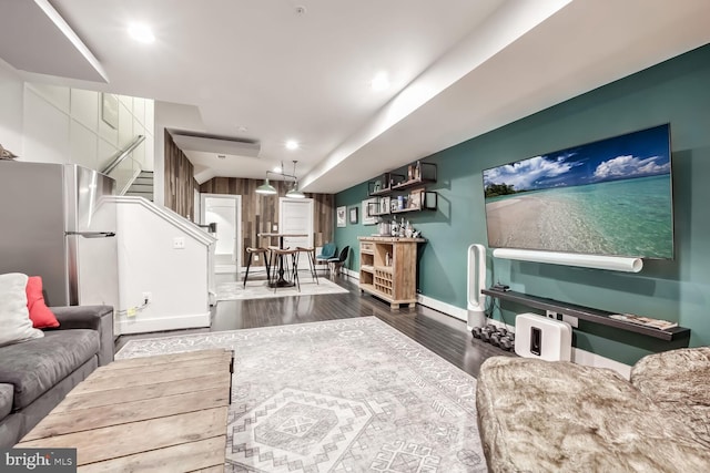 living room with baseboard heating and dark hardwood / wood-style floors