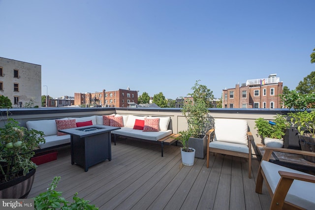 deck with an outdoor living space with a fire pit