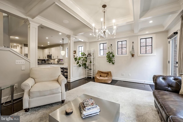 living room featuring decorative columns, coffered ceiling, a notable chandelier, dark wood-type flooring, and beam ceiling