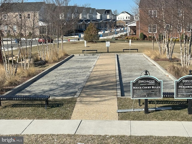 view of property's community with a lawn