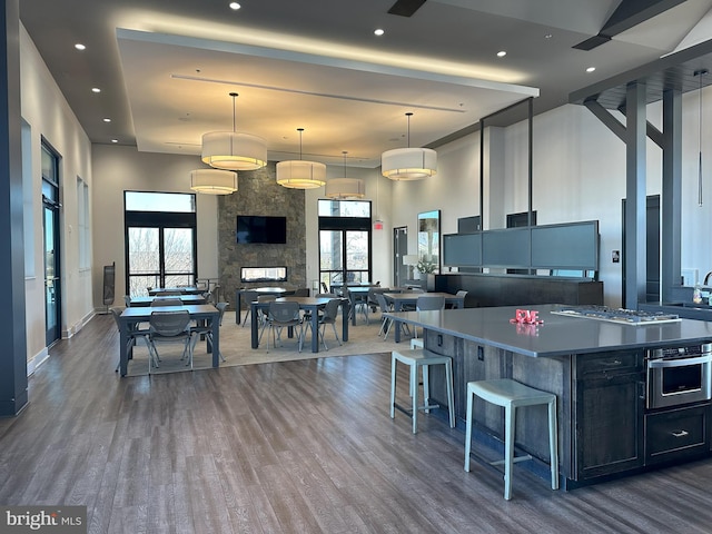 kitchen featuring a large island, decorative light fixtures, a wealth of natural light, and appliances with stainless steel finishes