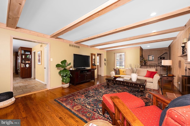 living room with recessed lighting, wood finished floors, visible vents, baseboards, and beamed ceiling