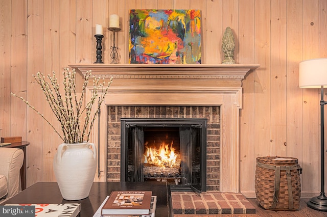 interior details with a brick fireplace and wood walls