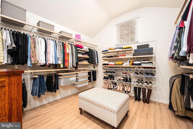 walk in closet with lofted ceiling and wood finished floors