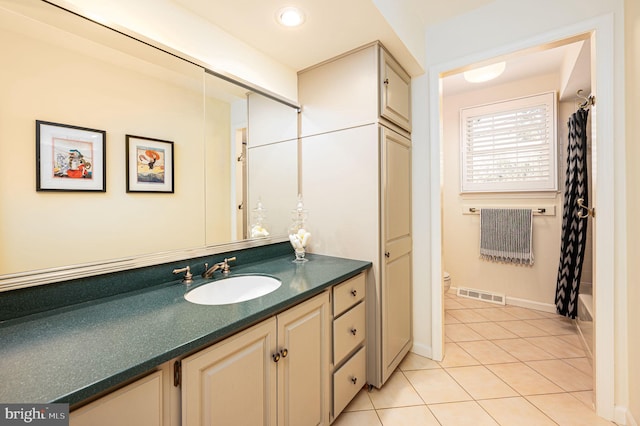 full bathroom with visible vents, baseboards, toilet, tile patterned flooring, and vanity