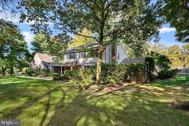 exterior space with stone siding and a front lawn