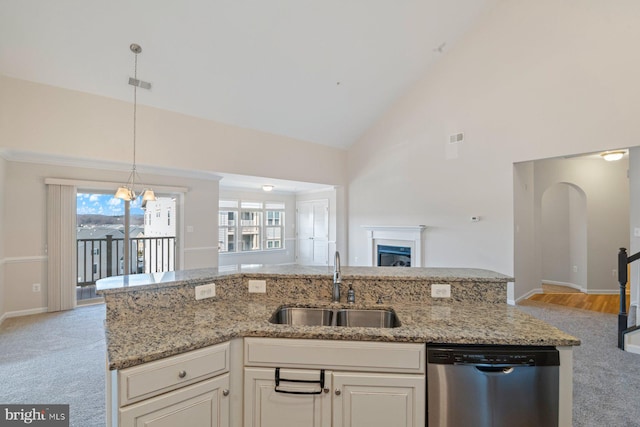 kitchen featuring dishwasher, light stone countertops, high vaulted ceiling, sink, and light colored carpet