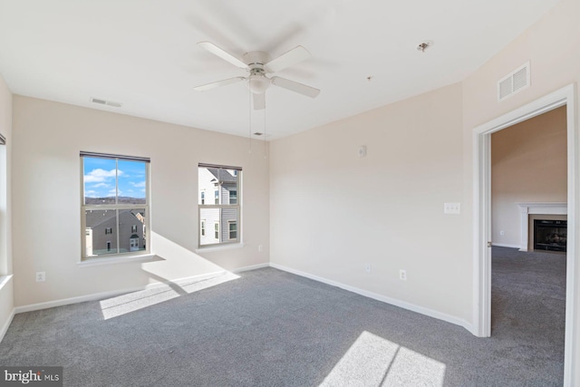 carpeted empty room with ceiling fan