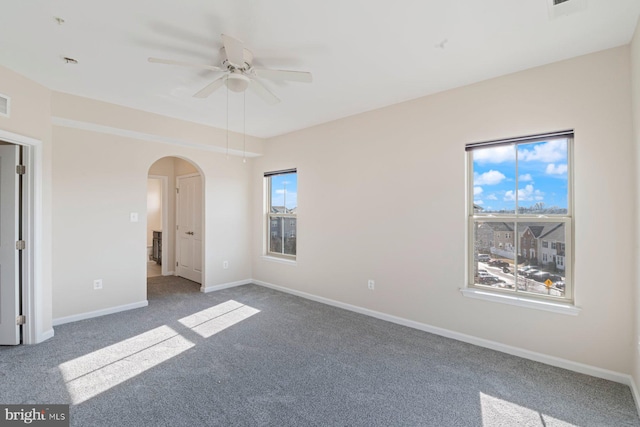 empty room with dark carpet and ceiling fan