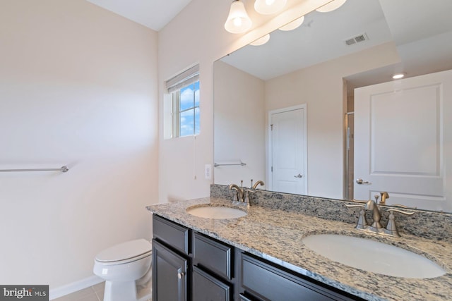 bathroom featuring toilet, tile patterned flooring, and vanity