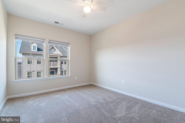 spare room featuring carpet flooring and ceiling fan