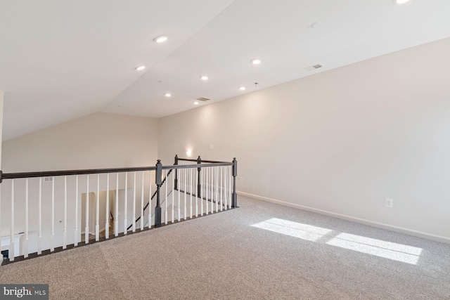 empty room with vaulted ceiling and carpet