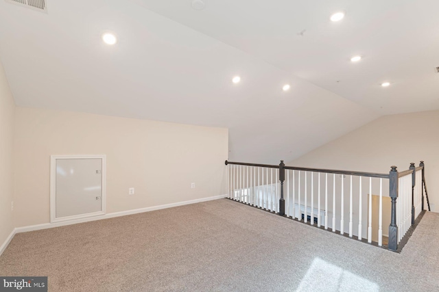 bonus room with vaulted ceiling and carpet flooring