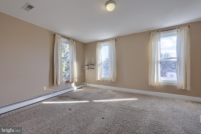 unfurnished room with a baseboard radiator, plenty of natural light, and carpet