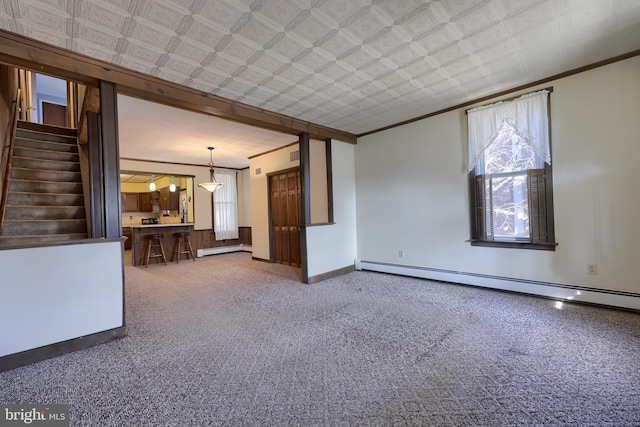 unfurnished living room featuring ornamental molding, a healthy amount of sunlight, and a baseboard heating unit