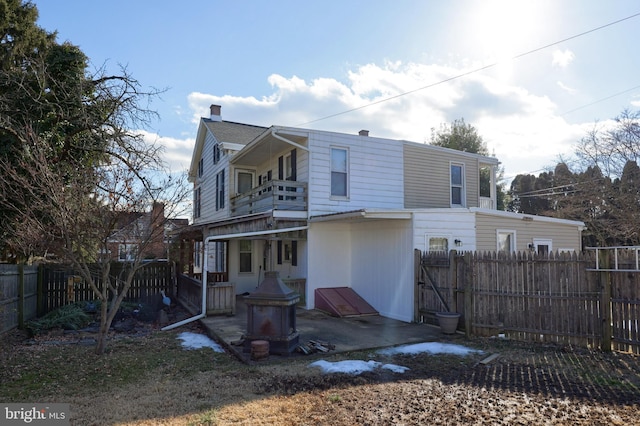 back of property featuring a balcony