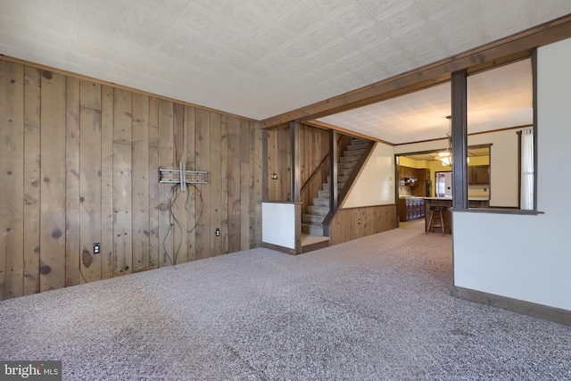 carpeted empty room with wooden walls