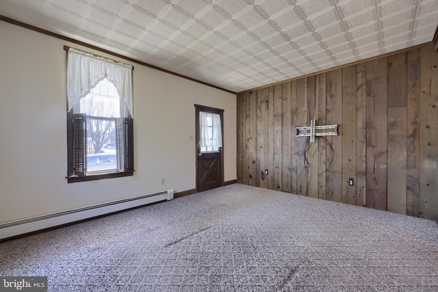 foyer entrance featuring carpet flooring, wooden walls, ornamental molding, and baseboard heating