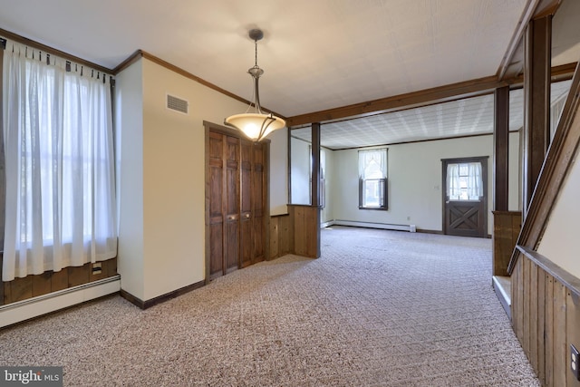 unfurnished room with crown molding, wooden walls, carpet, and baseboard heating