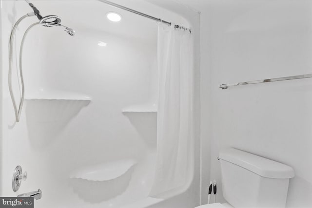 bathroom with toilet and curtained shower