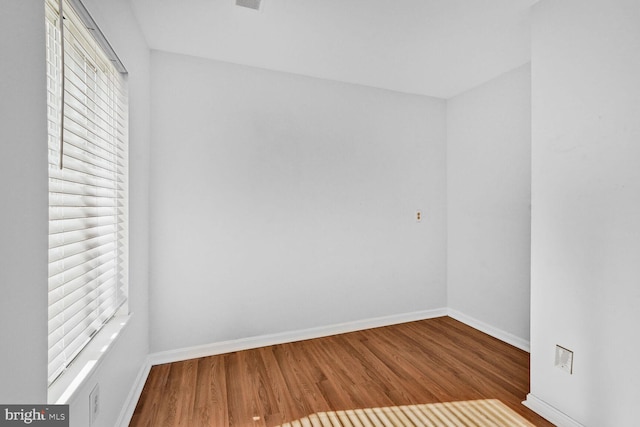 spare room with wood-type flooring