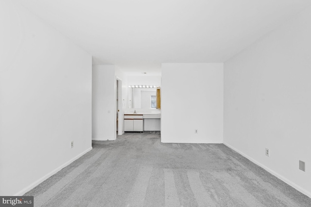 unfurnished living room featuring light colored carpet