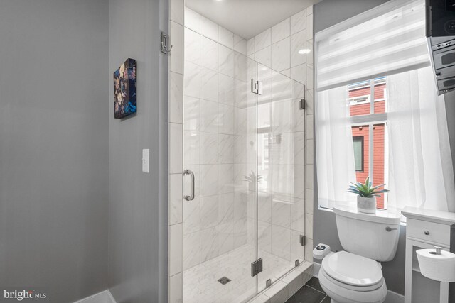 full bathroom with a shower stall and toilet