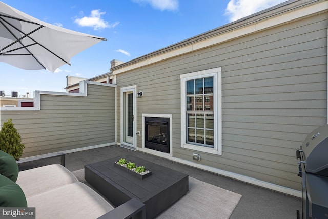 view of patio with area for grilling, outdoor lounge area, and fence