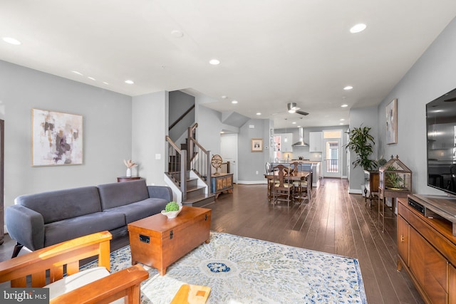 living area with dark wood finished floors, recessed lighting, baseboards, ceiling fan, and stairs