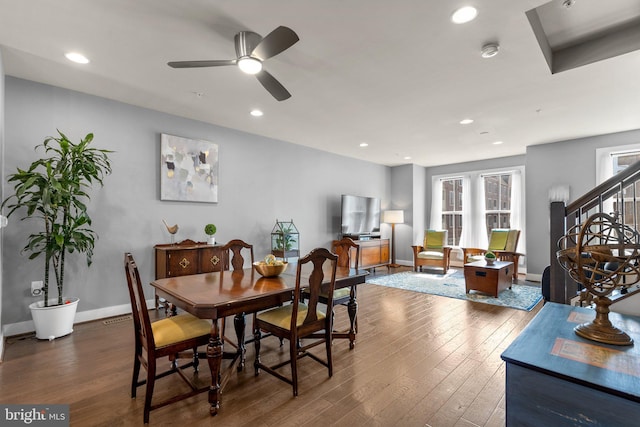 dining space with recessed lighting, baseboards, stairs, and hardwood / wood-style flooring