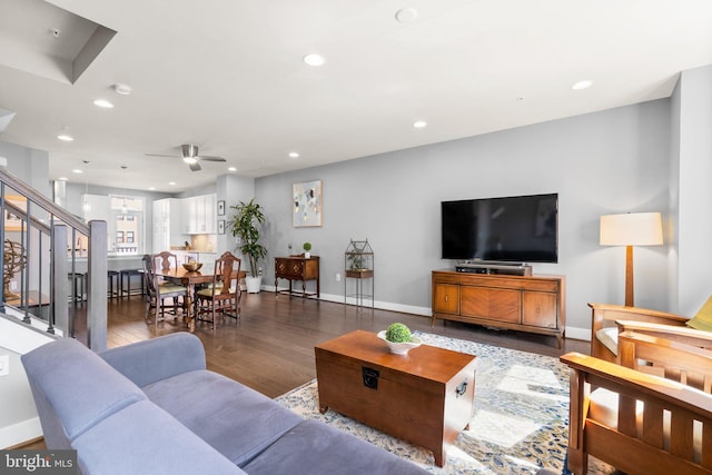 living room featuring stairs, recessed lighting, wood finished floors, and baseboards