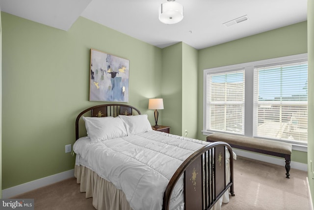 bedroom with carpet flooring, baseboards, and visible vents