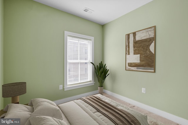 bedroom with visible vents, baseboards, and carpet floors