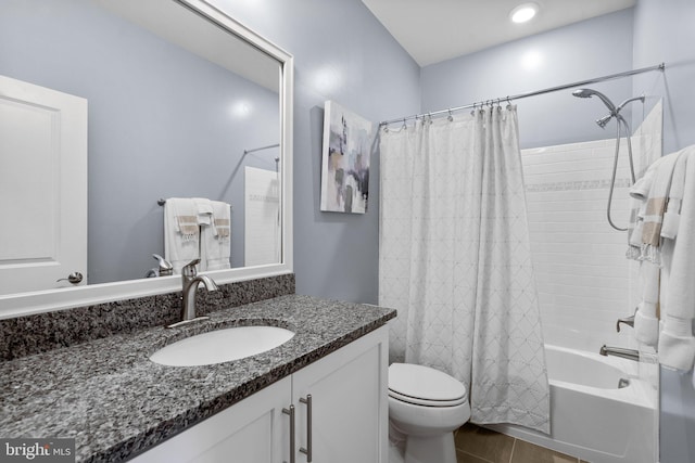 bathroom featuring shower / tub combo, toilet, and vanity