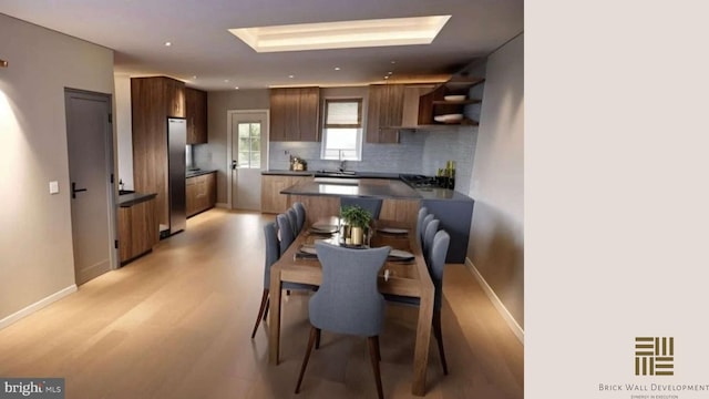 dining area with sink and light hardwood / wood-style flooring