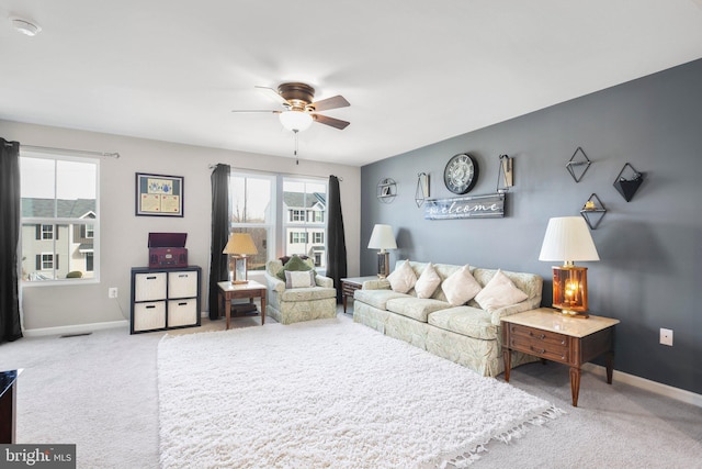 living room featuring a healthy amount of sunlight, carpet floors, and ceiling fan