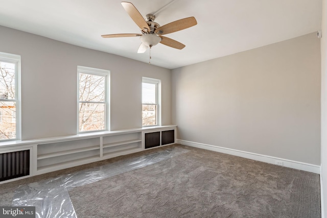 empty room featuring carpet and ceiling fan