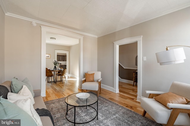 living room with hardwood / wood-style flooring and crown molding