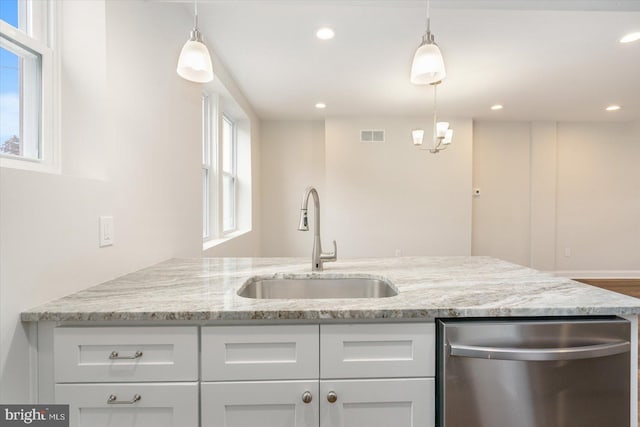 kitchen with sink, white cabinetry, light stone countertops, and dishwasher