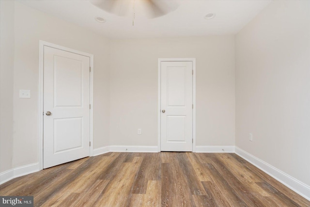 interior space with ceiling fan and dark hardwood / wood-style flooring